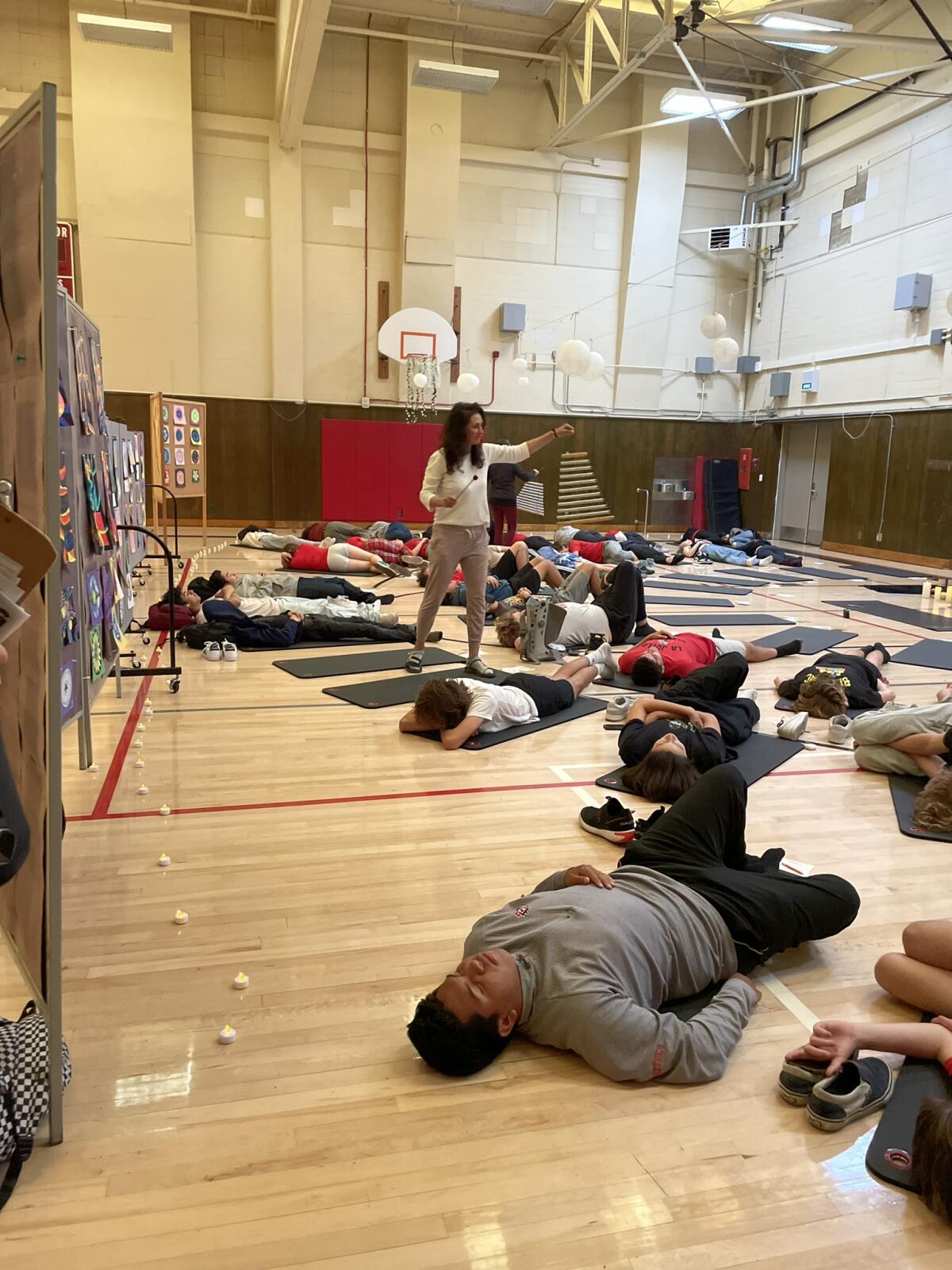 Local life coach Linda Vazin leads a breathwork session for La Jolla High School students in advance of final exams in June.