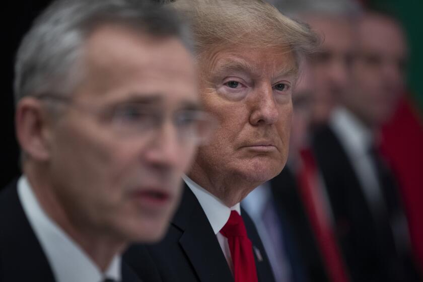 FILE - President Donald Trump listens as NATO Secretary General Jens Stoltenberg speaks during a working lunch with NATO members that have met their financial commitments to the the organization, at The Grove, Wednesday, Dec. 4, 2019, in Watford, England. Donald Trump says he once warned that he would allow Russia to do whatever it wants to NATO member nations that are “delinquent” in devoting 2% of their gross domestic product to defense. Trump’s comment on Saturday represented the latest instance in which the former president and Republican front-runner seemed to side with an authoritarian state over America’s democratic allies. (AP Photo/ Evan Vucci, File)