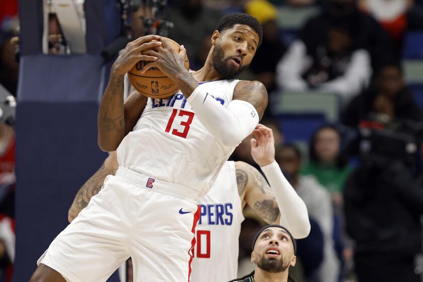 Los Angeles Clippers forward Paul George (13) grabs a rebound in front of New Orleans Pelicans.