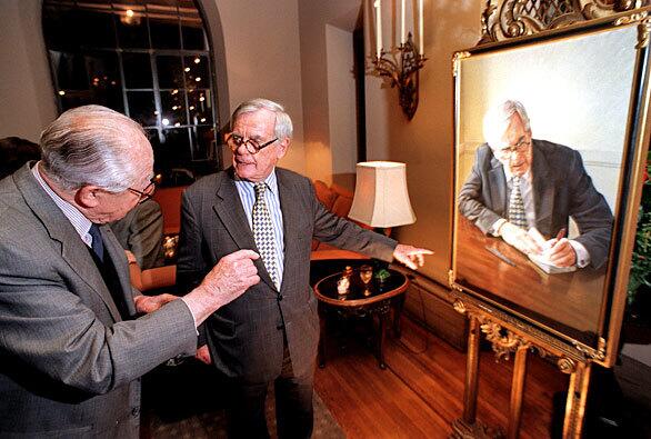 Dominick Dunne shows his portrait by Sacha Newley to director Billy Wilder, left, at a cocktail reception at the Chateau Marmont in West Hollywood for a Newley exhibition. "I told Sacha I can't just sit there, so I just worked away, writing in my notebooks," Dunne said of his sittings for the painting.