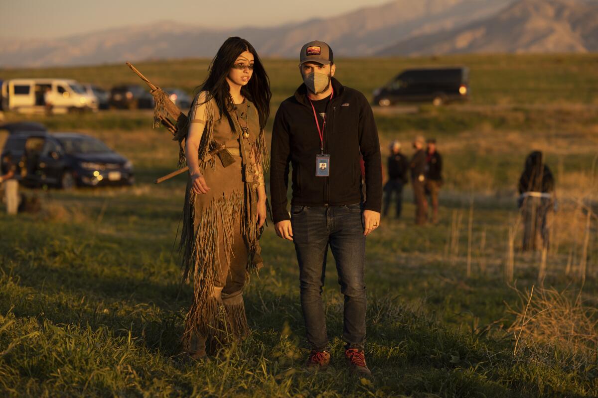 An indigenous actress in costume as an 18th century Comanche confers with her director on the location set of "Prey."