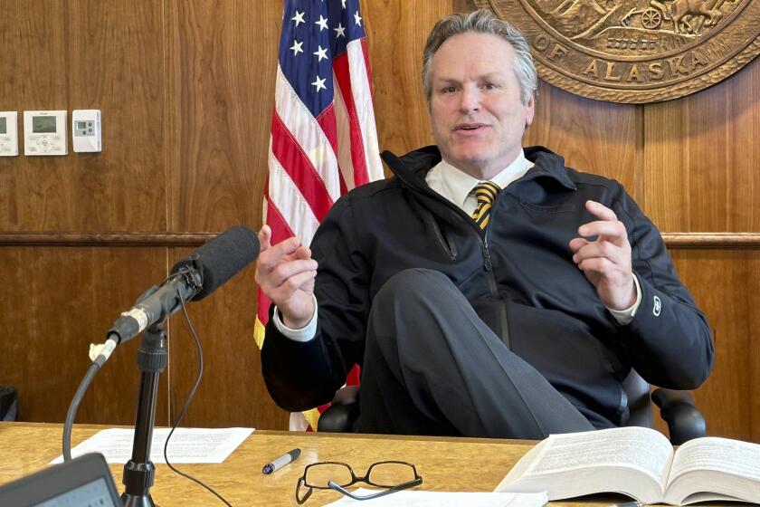 FILE - Alaska Gov. Mike Dunleavy gestures while speaking with reporters on May 1, 2024, in Juneau, Alaska. (AP Photo/Becky Bohrer, File)