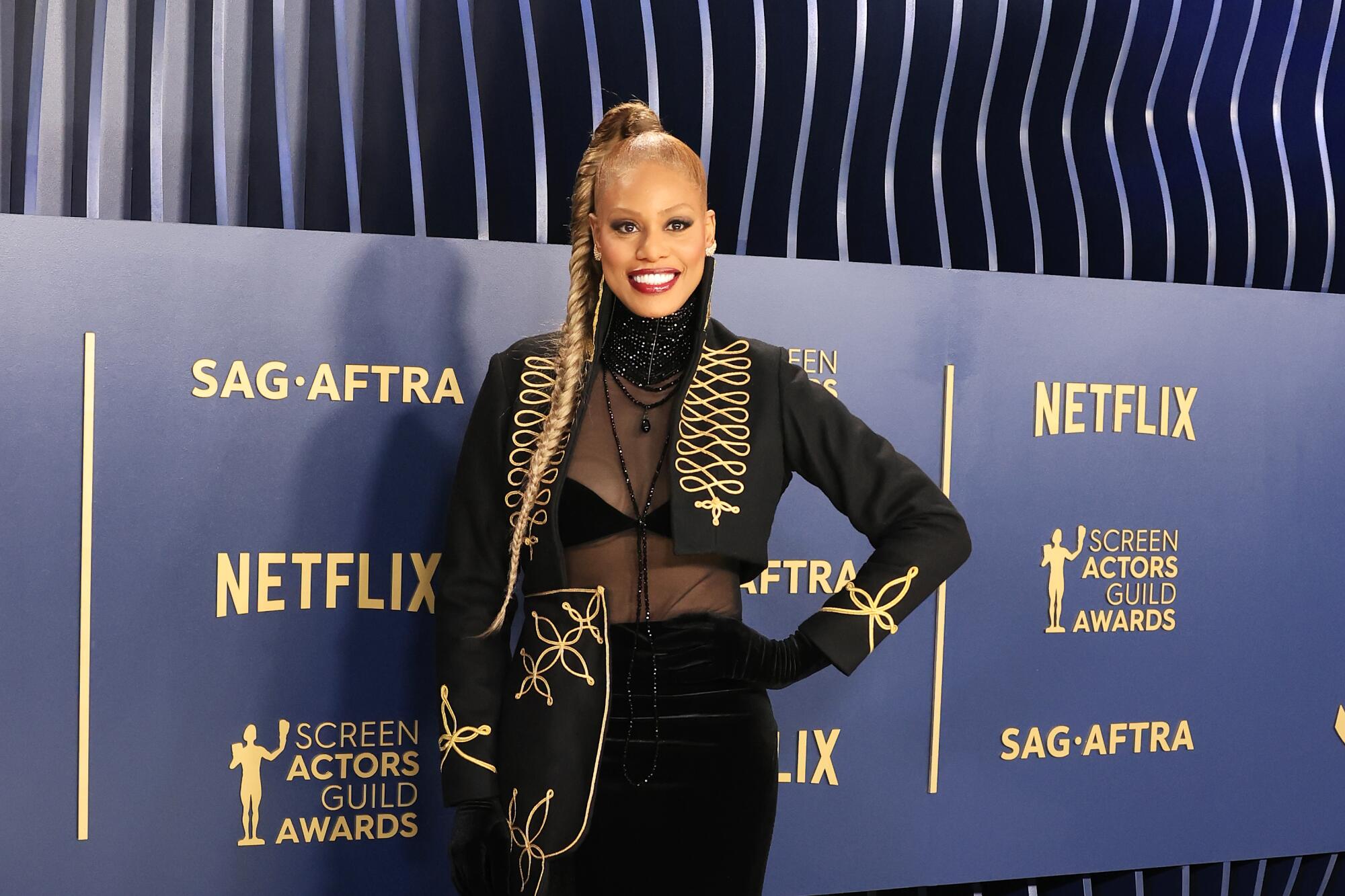 Laverne Cox wears a black ensemble with gold details at the SAG Awards.