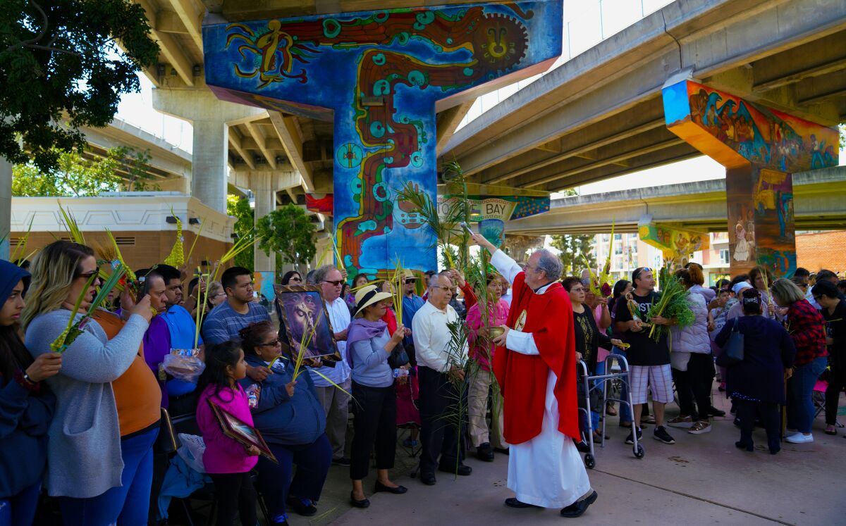 Our Lady of Guadalupe parish members with Father John Authur in 2019 during the annual Palm Sunday celebration held at Chicano Park in Barrio Logan.