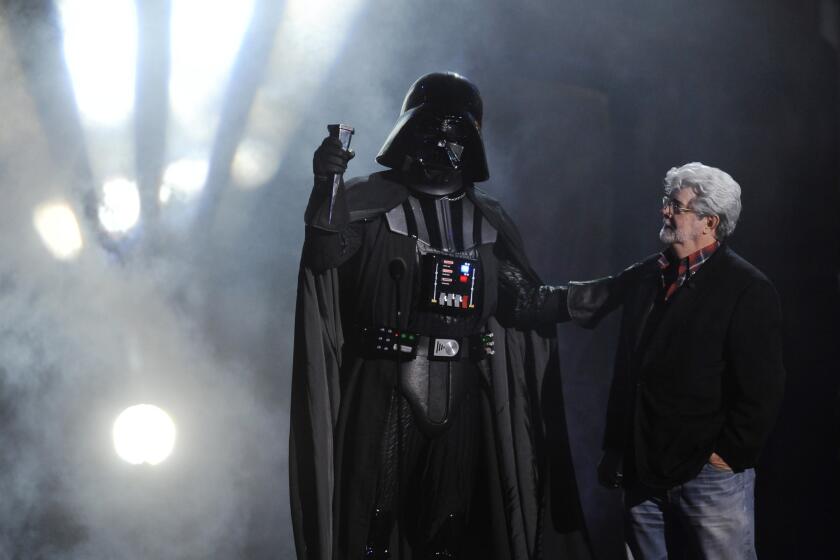 Darth Vader accepts the Ultimate Villain award from "Star Wars" creator George Lucas during the 2011 Scream Awards in Los Angeles.