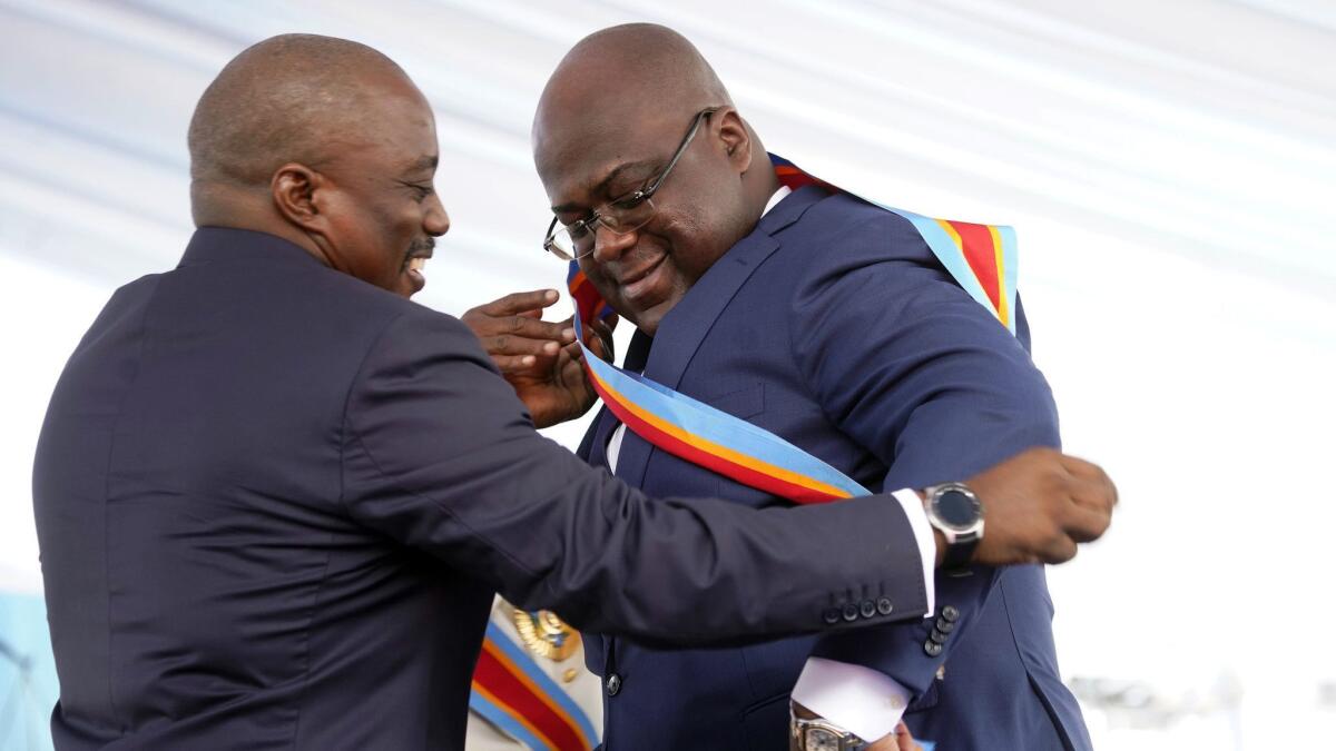Congolese President Felix Tshisekedi receives the presidential sash from outgoing President Joseph Kabila after being sworn in in the capital, Kinshasa, on Thursday.