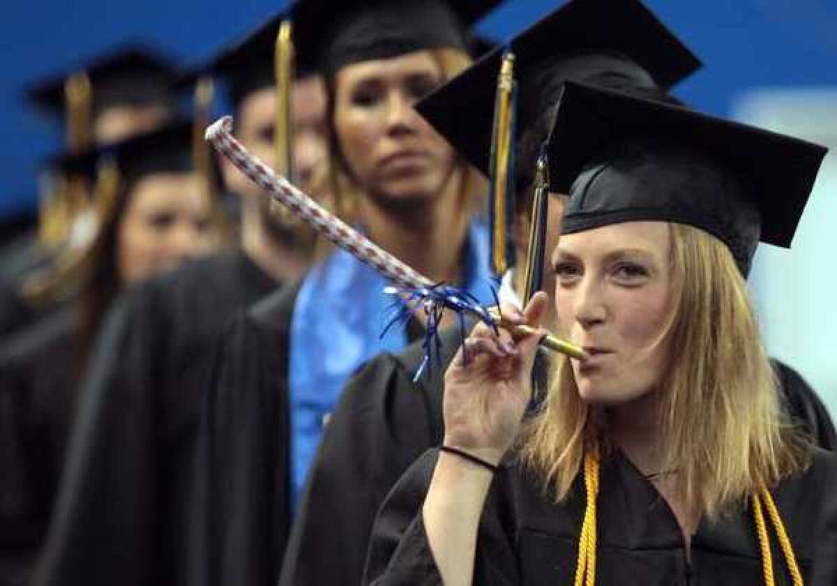 In this May 13, 2012, file photo, Morgan Simpson celebrates her graduation during the processional of the University of Alaska Fairbanks commencement at the Carlson Center in Fairbanks, Alaska