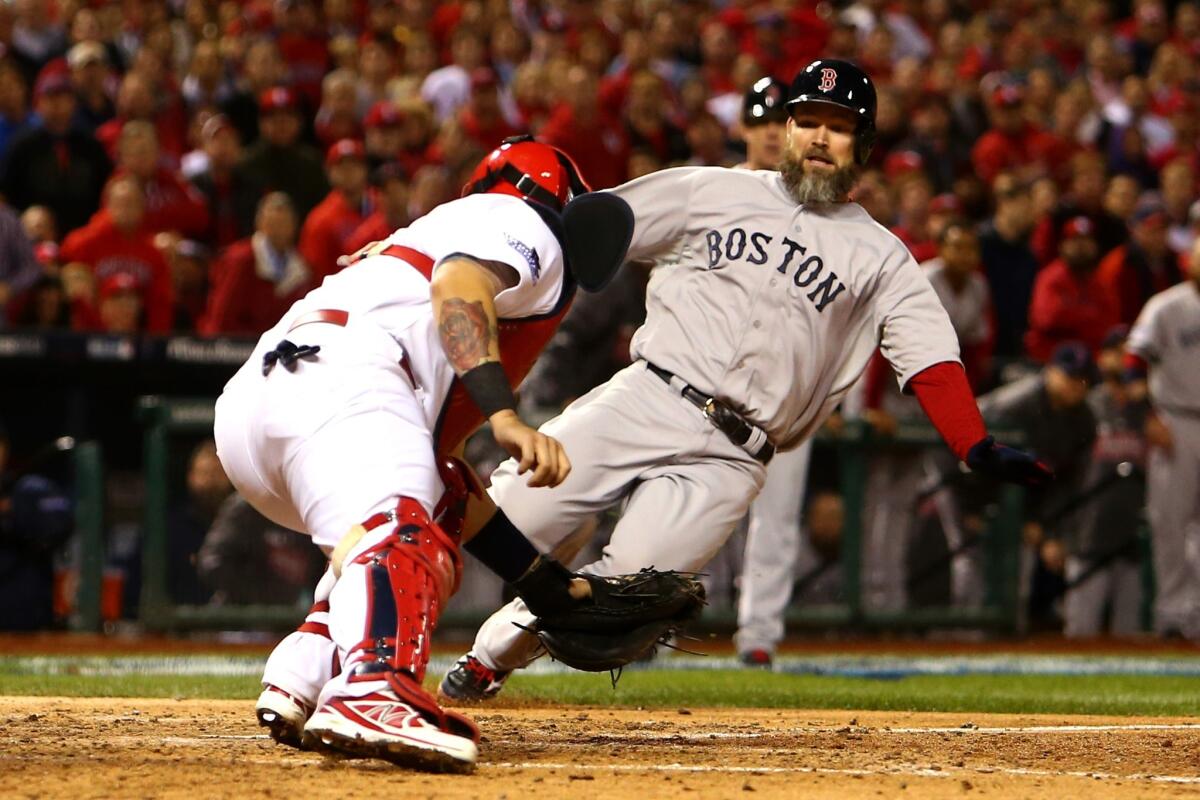 Yadier Molina of the St. Louis Cardinals gets the out on David Ross of the Boston Red Sox at home plate in Game 5 of the 2013 World Series. Fox's coverage of the Fall Classic won the Sports Emmy for outstanding live special.