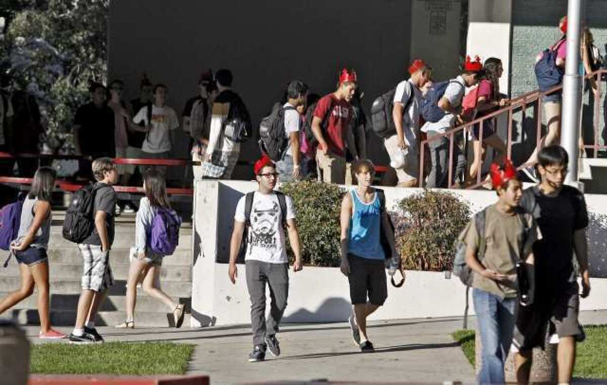 Students rush off to class during the first day of the new school year at La Canada High School in La Canada Flintridge.