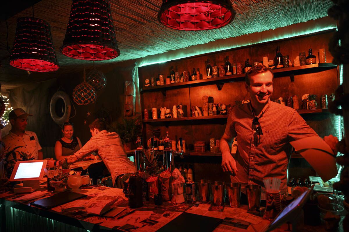 PDT bartenders Christian Hurtado, left, and Adam Schmidt, right, prepare Tiki themed cocktails inside of the secret tiki bar PDTiki during weekend one of the three-day Coachella Valley Music and Arts Festival at the Empire Polo Grounds on Saturday, April 15, 2017 in Indio, Calif. Goldenvoice food and beverage director Nic Adler teamed with the bartenders at PDT (Please Don't Tell) in Manhattan, New York, to open a 35-person bar in the general admission area. An assortment of restaurants and chefs are providing unique food and crafted drink options for the festival. (Patrick T. Fallon/ For The Los Angeles Times)