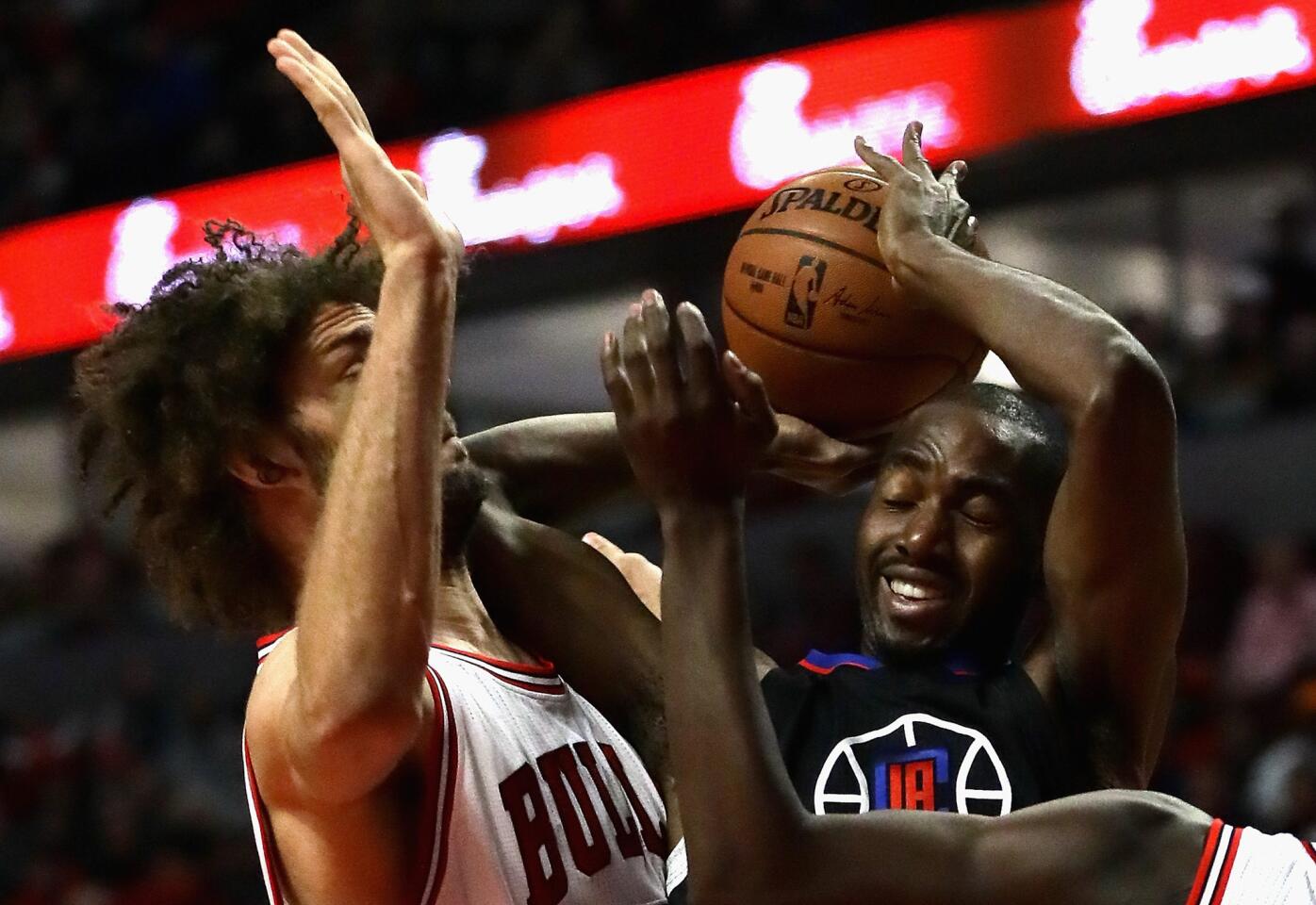Clippers forward Luc Mbah a Moute is fouled by Bulls center Robin Lopez during the first half.