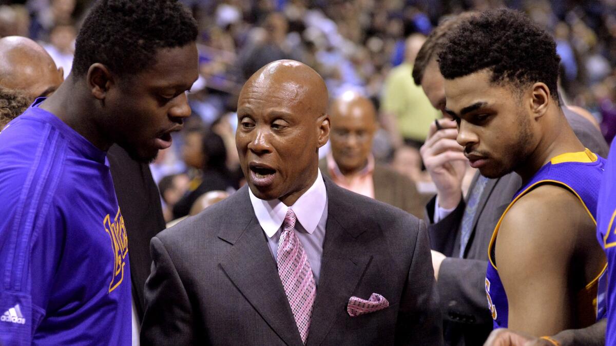 Lakers Coach Byron Scott says second-year forward Julius Randle, left, and rookie guard D'Angelo Russell, right, must start playing "like a brotherhood" with other young players on the team.