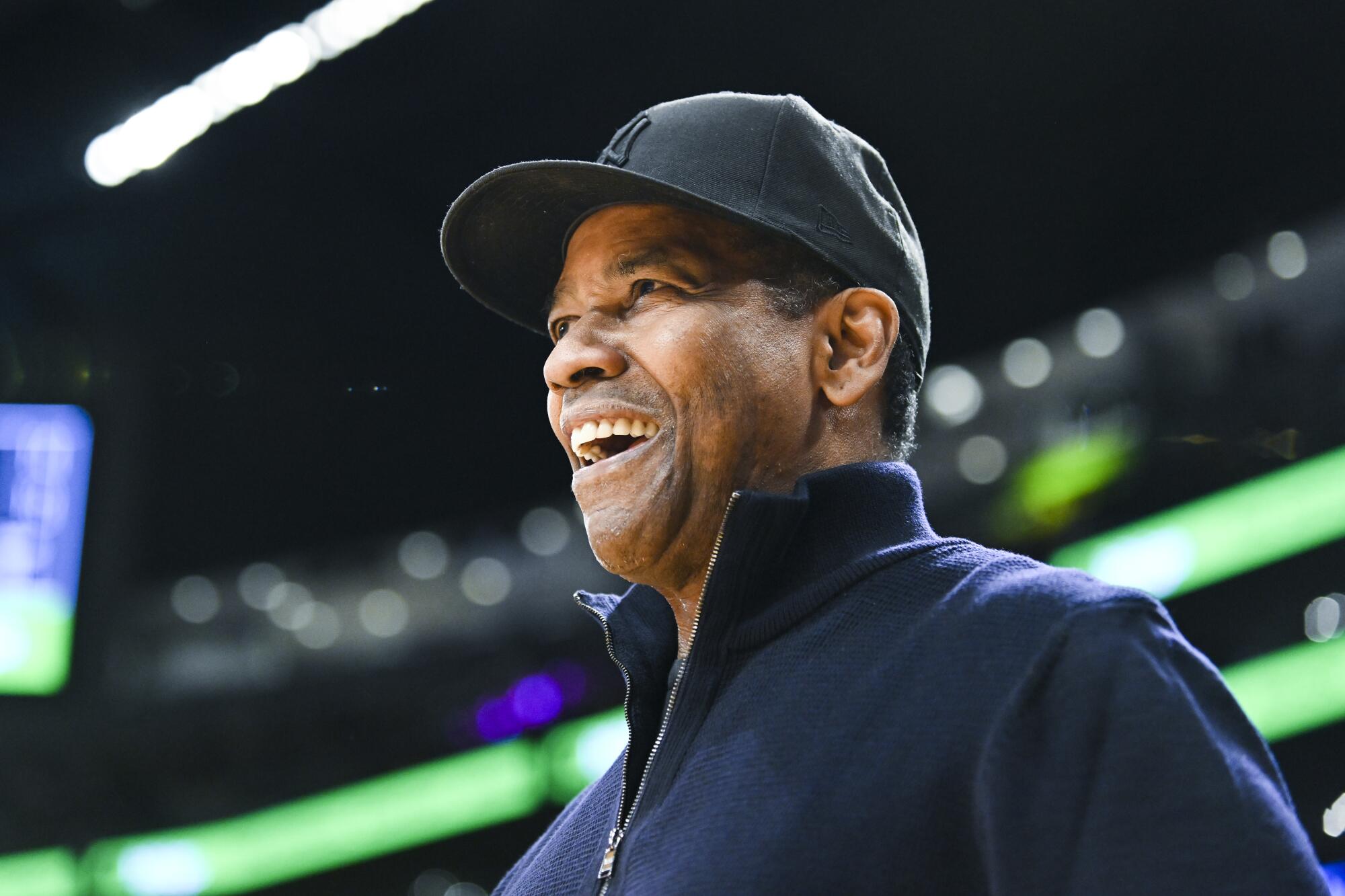 Actor Denzel Washington watches the game during the first quarter.
