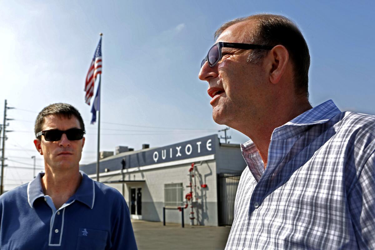 Steve Dayan, right, secretary-treasure of Teamsters local 399 talks as Adam Roodman , left, vice president of Quixote, listens as Teamsters local 399 talk outside Quixote Studios on Penrose in Los Angeles.