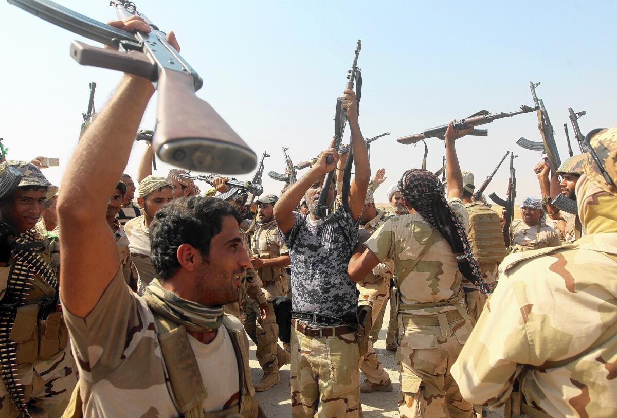 Iraqi fighters celebrate after helping break Islamic State militants' siege on the town of Amerli.