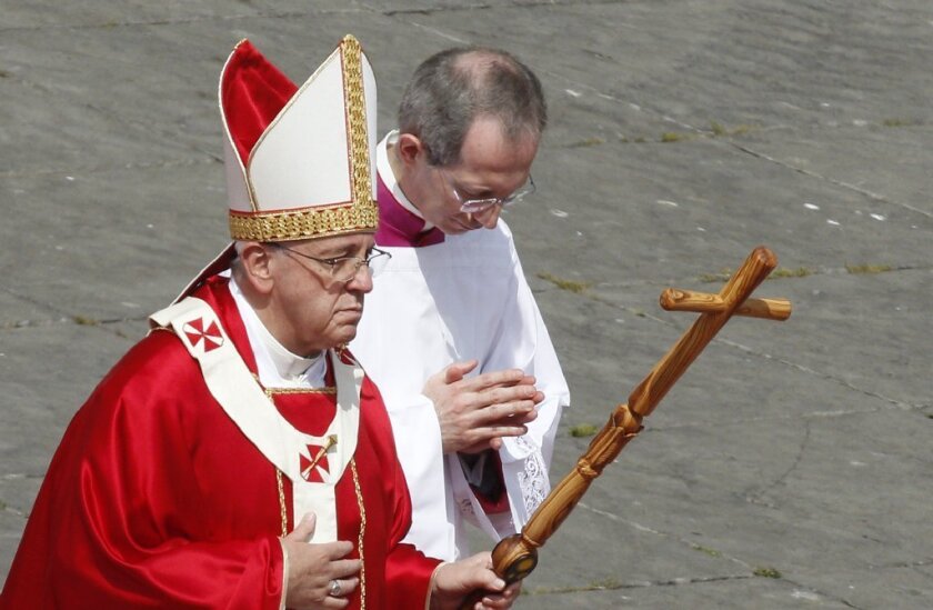 Pope Francis, attended by Guido Marini, his master of ceremonies, leaves Palm Sunday Mass in St. Peter's Square on April 13.