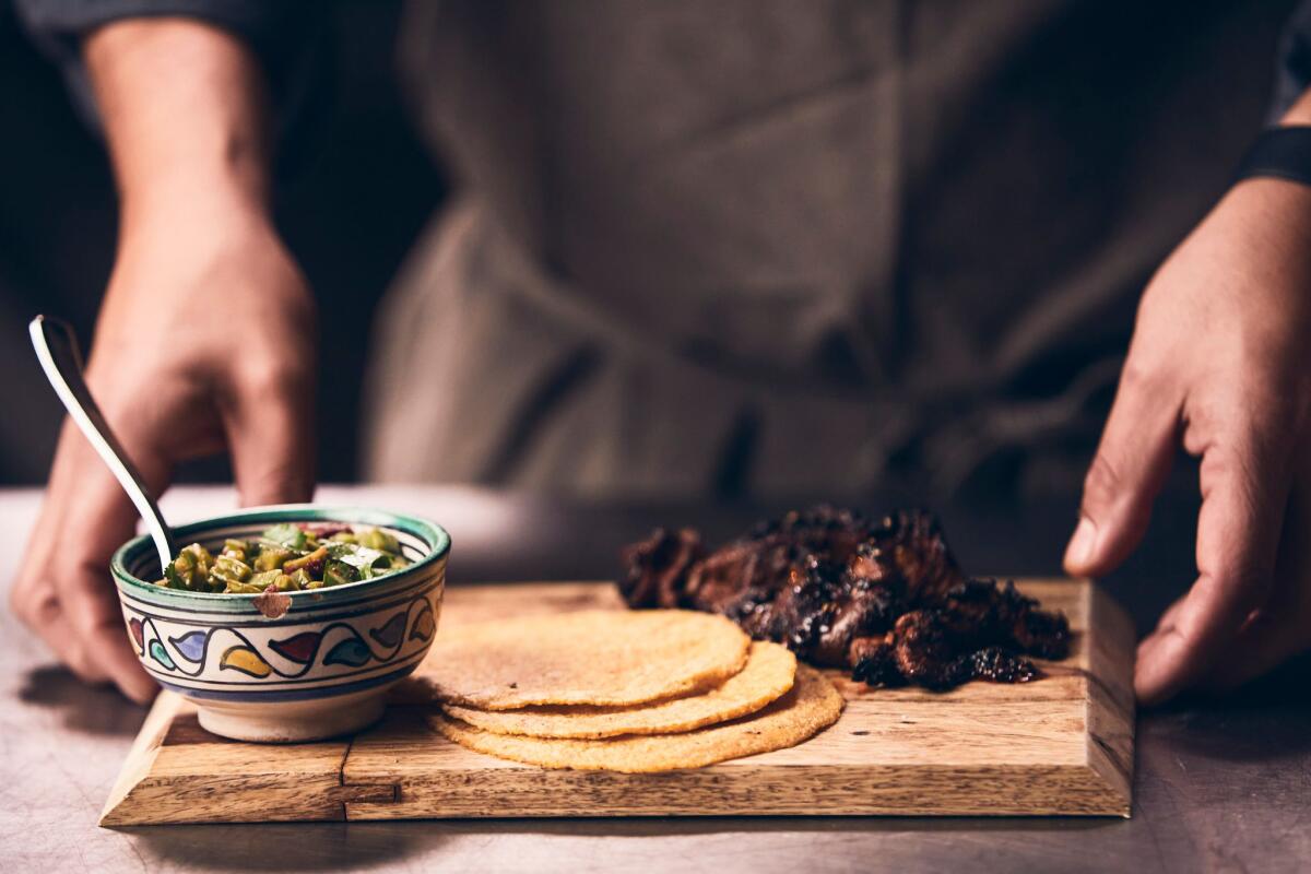 Broken Spanish's salsa, meat and tortillas on a wooden board