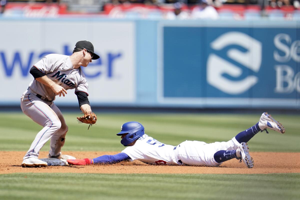 Dodgers baserunner Mookie Betts steals second base in front of Miami's Joey Wendle on Sunday.