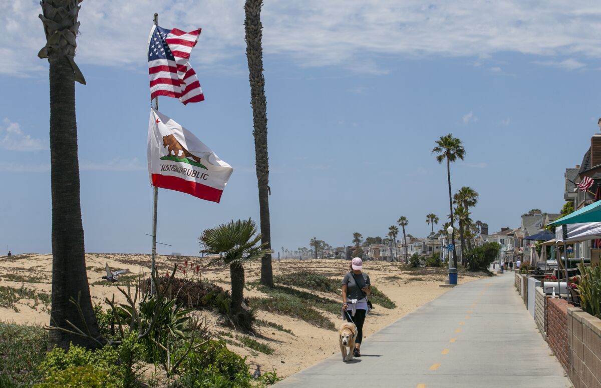 A Newport Beach flagpole slated for removal for encroaching on public land got a reprieve when neighbors complained.