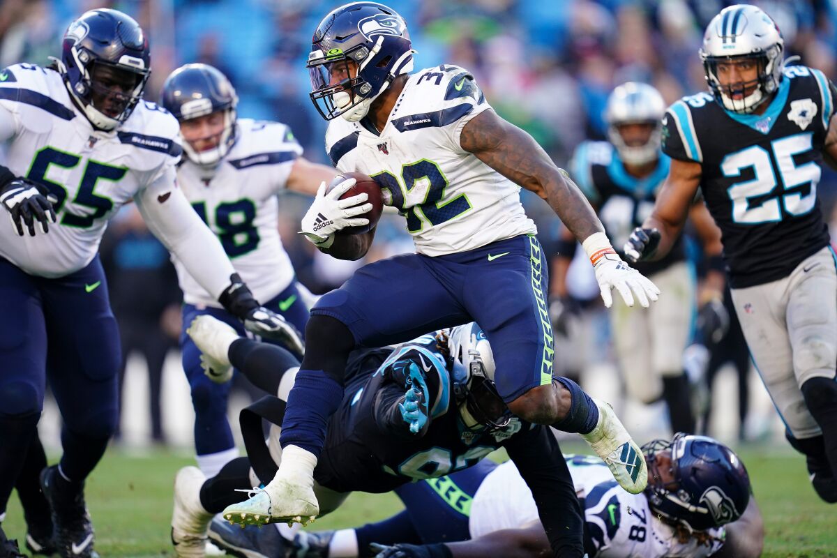 Seattle Seahawks running back Chris Carson runs with the ball against the Carolina Panthers on Sunday.