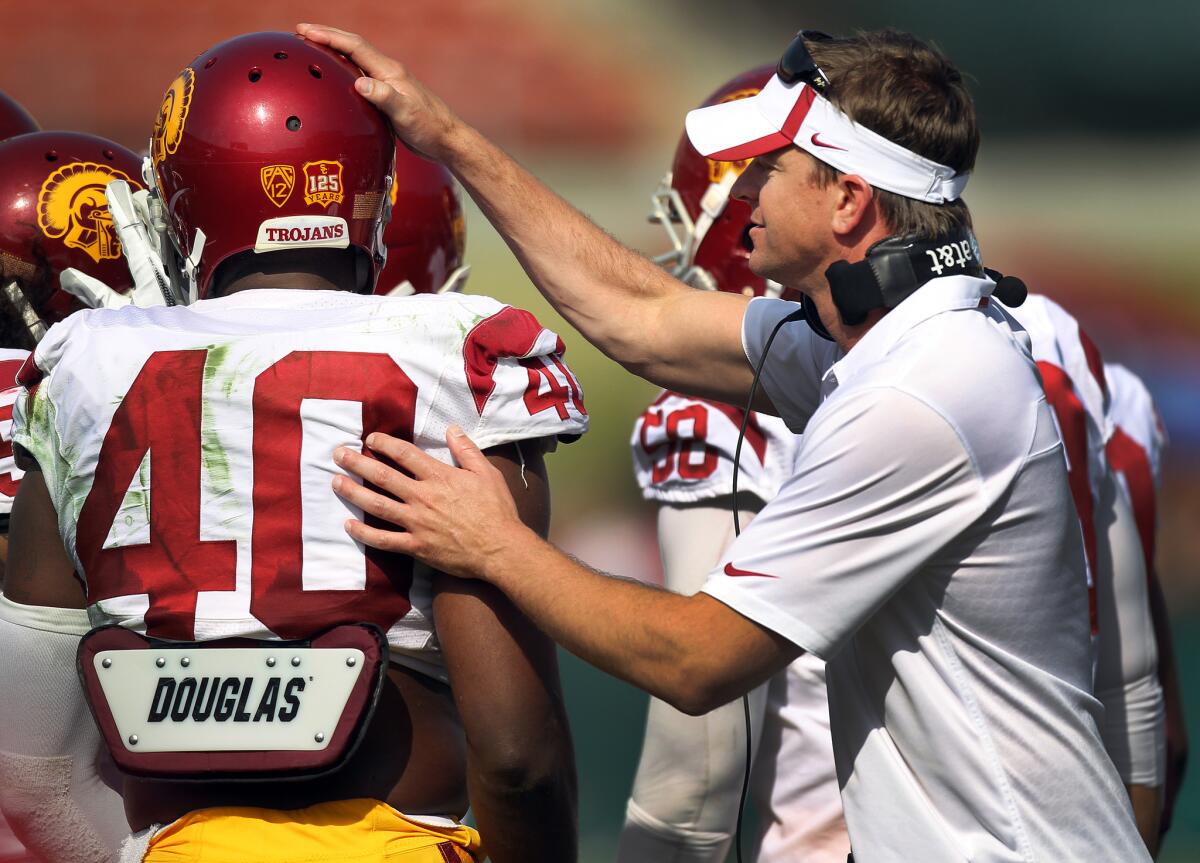 USC defensive coordinator Justin Wilcox gives Jabari Ruffin a pat on the helmet last year.