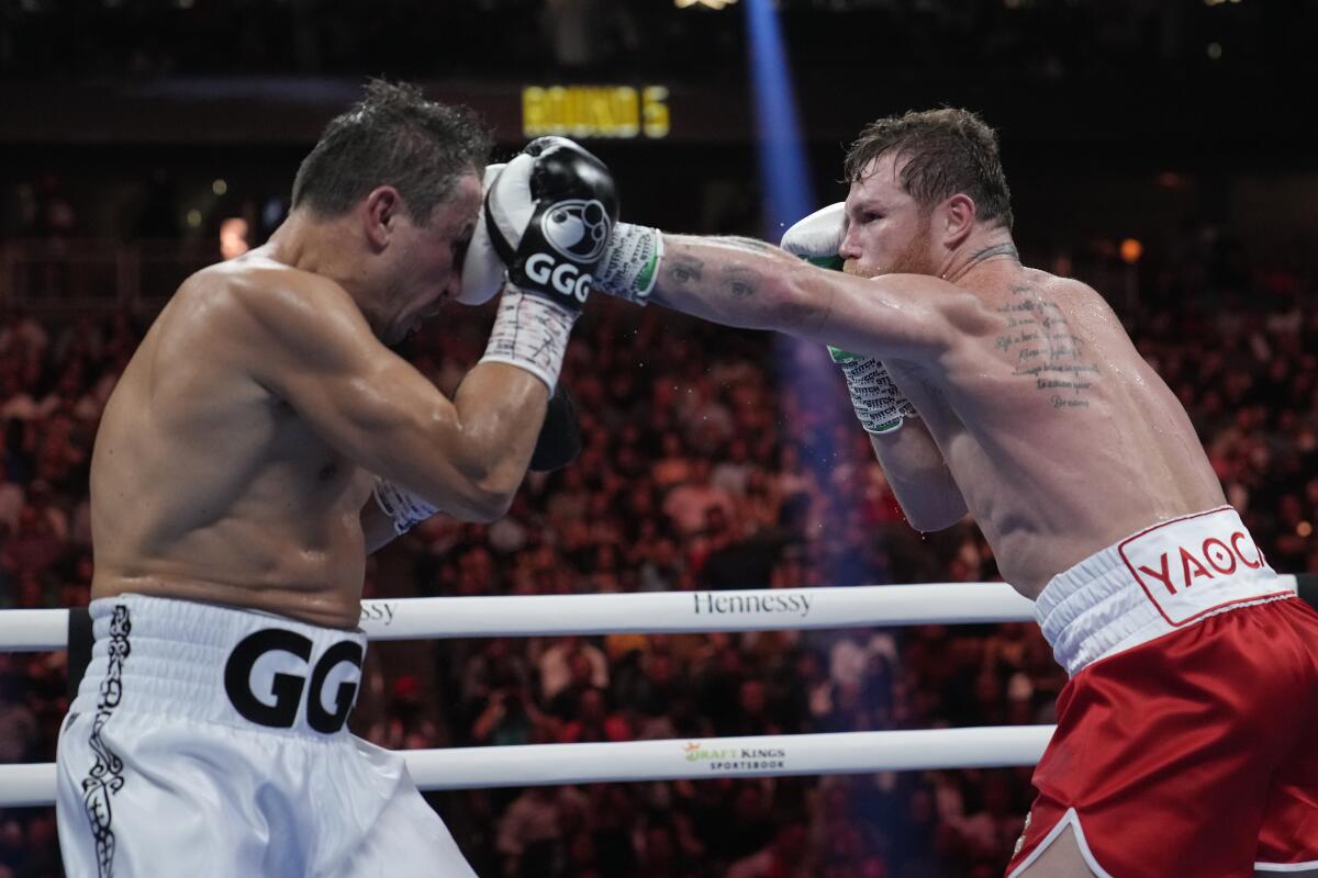 Canelo Álvarez lands a left to the head of Gennadiy Golovkin during their fight Saturday.