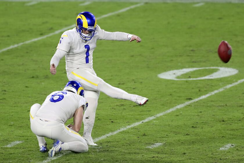 Los Angeles Rams' Matt Gay (1) kicks a field goal against the Tampa Bay Buccaneers during the second half of an NFL football game Monday, Nov. 23, 2020, in Tampa, Fla. Holding is Johnny Hekker (6). (AP Photo/Mark LoMoglio)