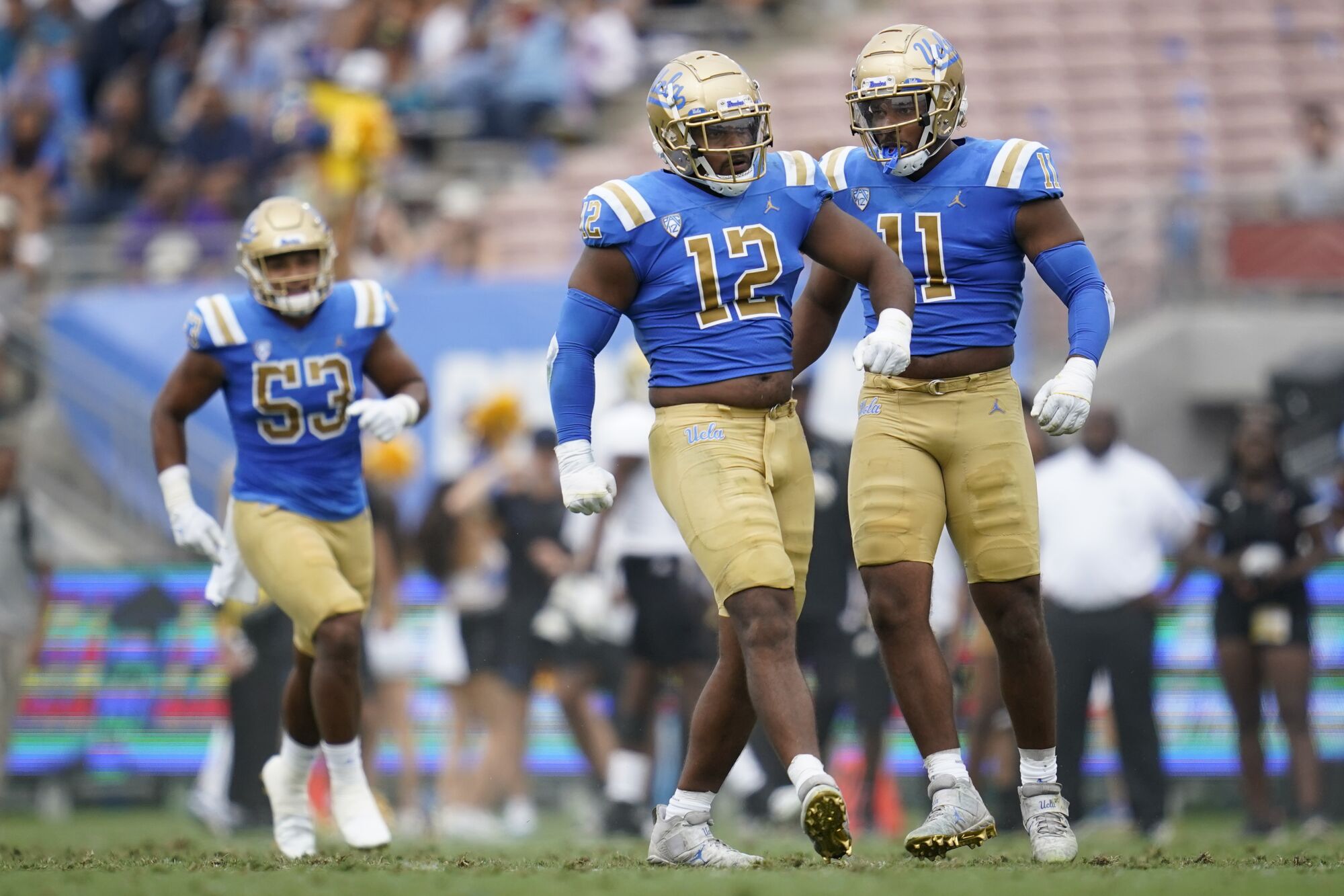 Grayson Murphy and Gabriel Murphy walk jauntily on the field.