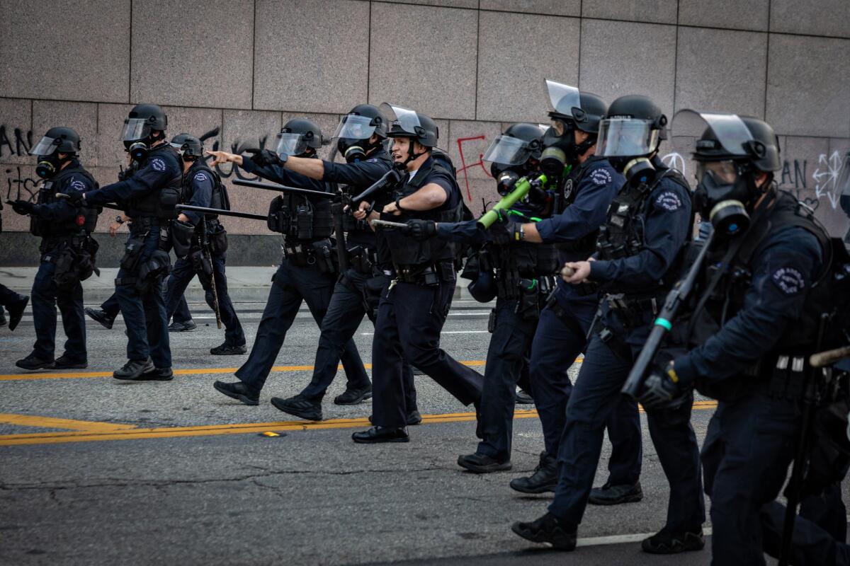 A row of law enforcement officials on the street.