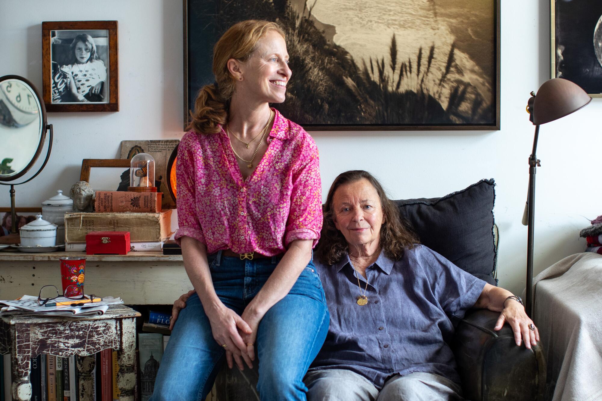 Lara Porzak sits on the arm of a chair beside her mother, Marianne Wiggins 