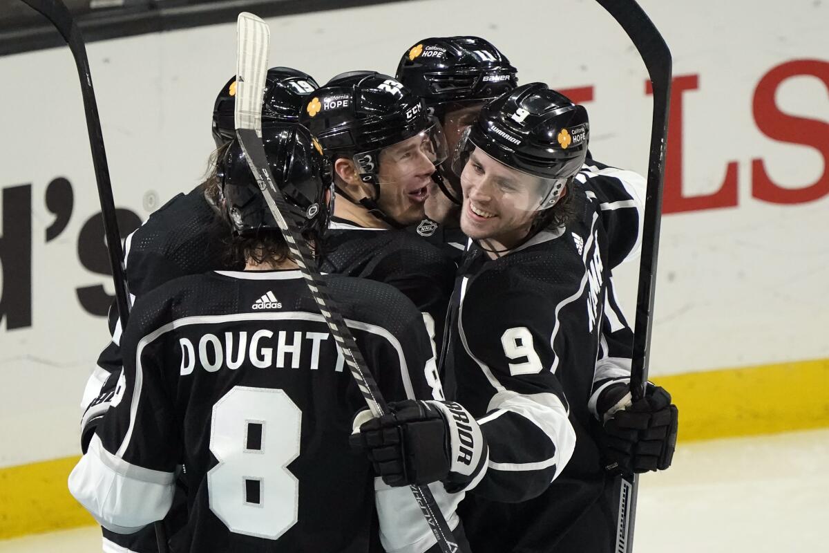 The Kings' Dustin Brown (23), center, celebrates with teammates after scoring in the third period March 5, 2021.
