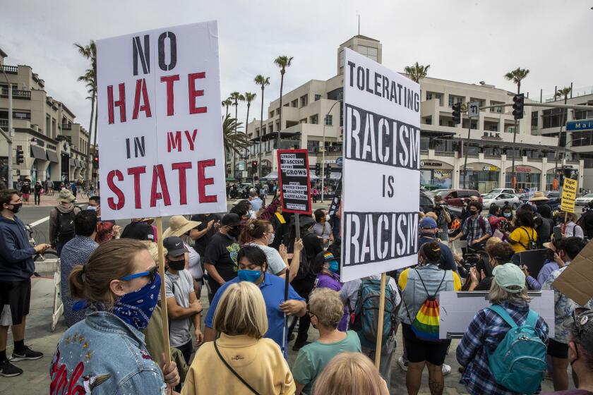 HUNTINGTON BEACH, CA - APRIL 11: Protesters gather in HB BLM RALLY on Sunday, April 11, 2021 in Huntington Beach, CA. (Brian van der Brug / Los Angeles Times)