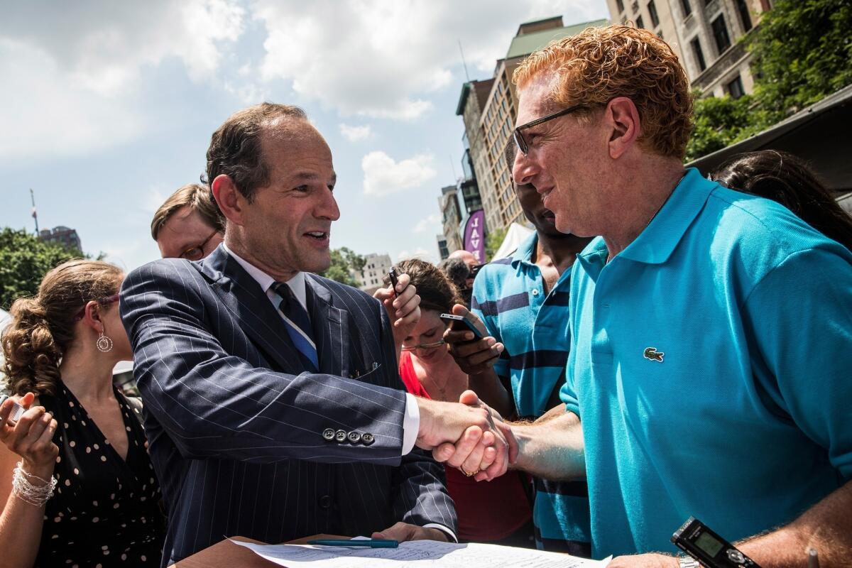 Former Gov. Eliot Spitzer collects signatures in New York on Monday so he can run for city comptroller. Spitzer resigned as governor in 2008 after it was discovered that he was using a high-end call girl service.