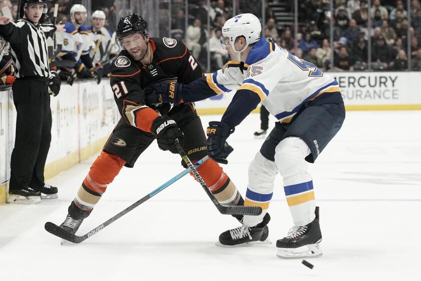 Anaheim Ducks right wing David Backes, left, passes around St. Louis Blues defenseman Colton Parayko during the second period of an NHL hockey game in Anaheim, Calif., Wednesday, March 11, 2020. (AP Photo/Chris Carlson)