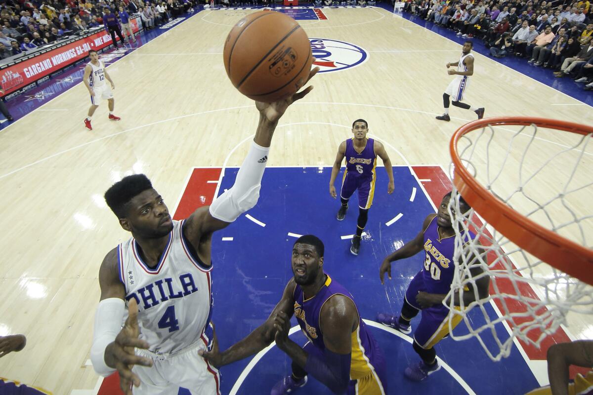 76ers forward Nerlens Noel goes up for a shot against Lakers center Roy Hibbert during the first half.