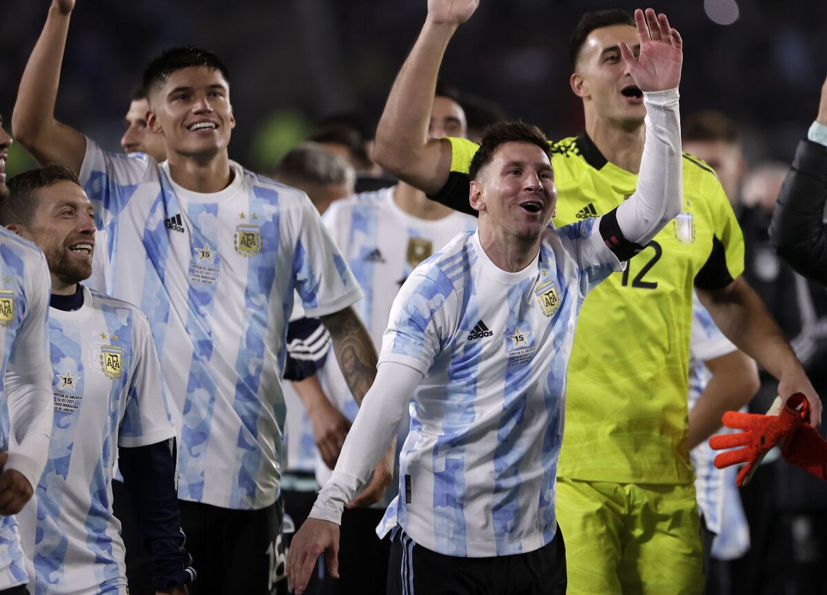 Argentina's players celebrate at the end a qualifying soccer match for the FIFA World Cup Qatar 2022