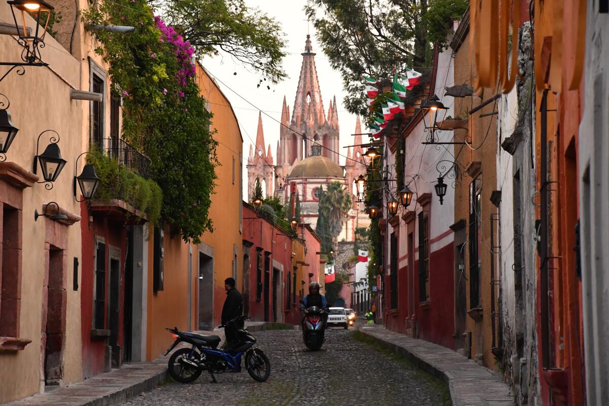 Calle Aldama, in the historic center of Mexico's San Miguel de Allende, includes cobblestones and views of La Parroquia church, whose towers date to the 19th century.