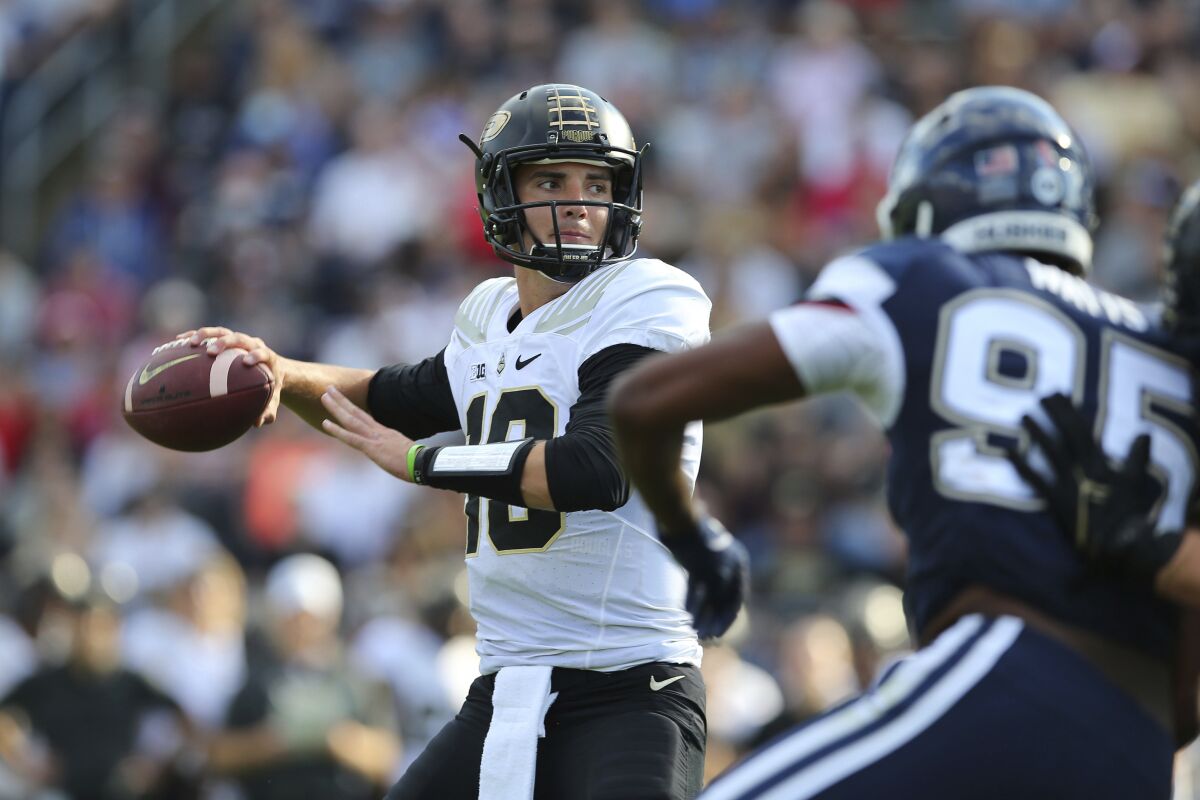 Purdue quarterback Jack Plummer (13) throws a touchdown pass during the first half of an NCAA football game against Connecticut on Saturday, Sept. 11, 2021, in East Hartford, Conn. (AP Photo/Stew Milne)