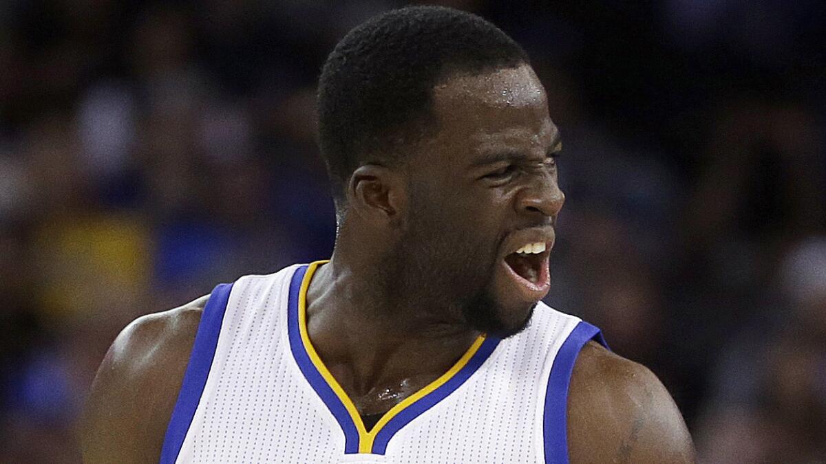 Golden State Warriors forward Draymond Green celebrates after scoring against the Clippers.