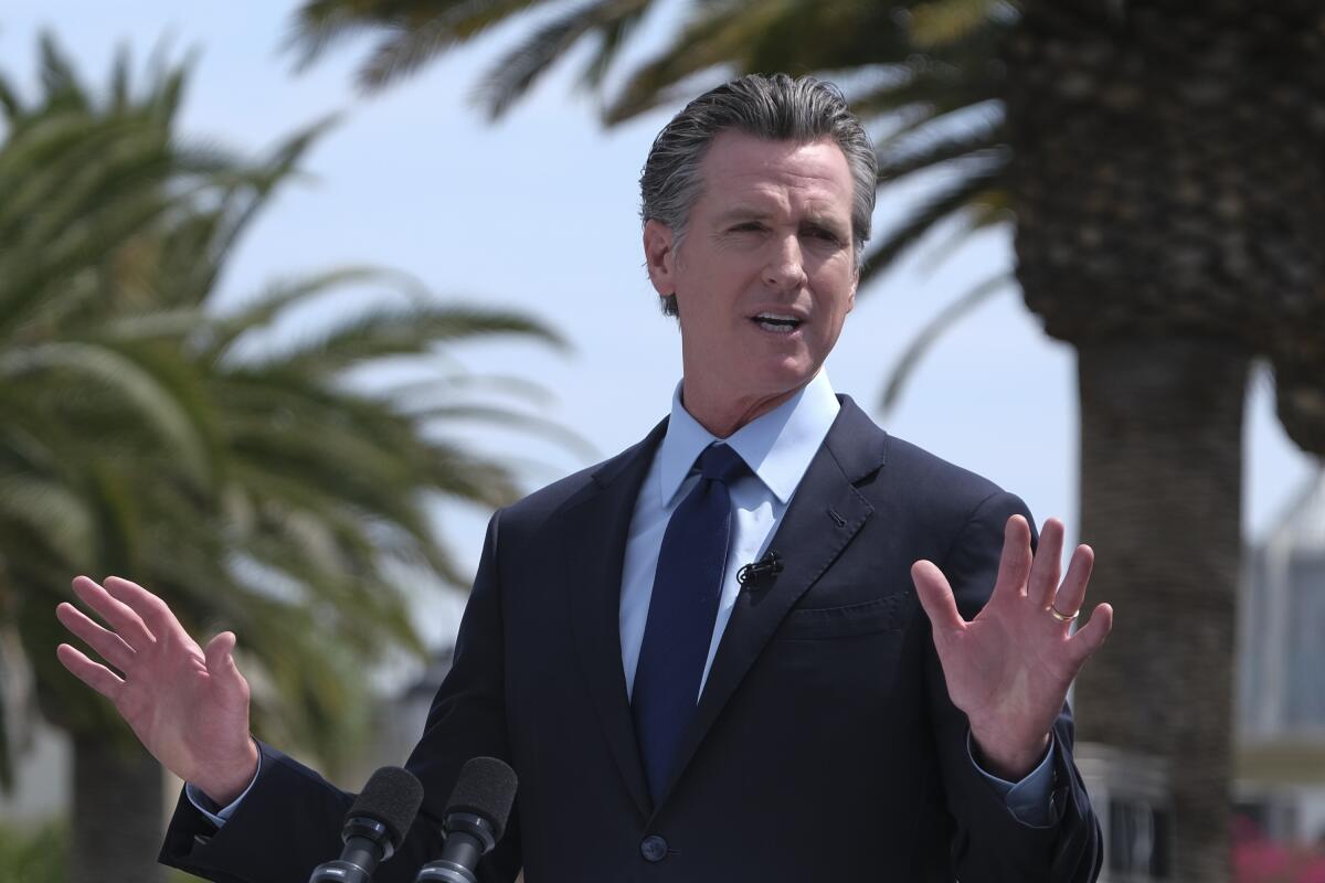 Gov. Gavin Newsom talks during a news conference at Universal Studios