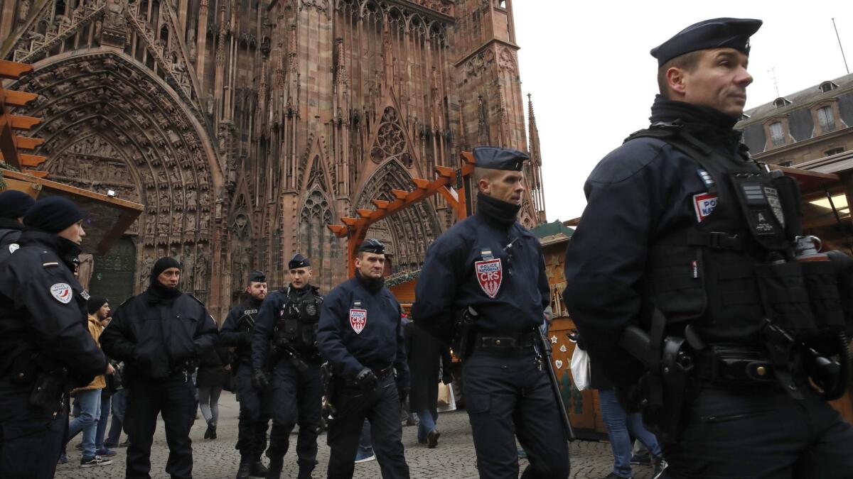 French police officers patrol outside the cathedral as the Christmas market reopens in Strasbourg, France, on Dec. 14.