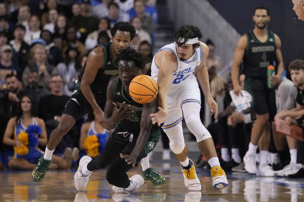 UCLA guard Jaime Jaquez Jr., right, steals the ball from Sacramento State forward Akol Mawein.