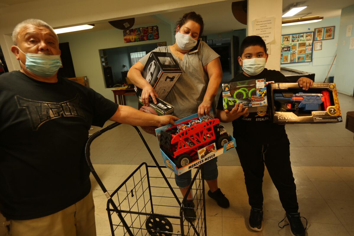 Felix Monroy Jr., 8, holds toys given to him at the Wilmington Teen Center