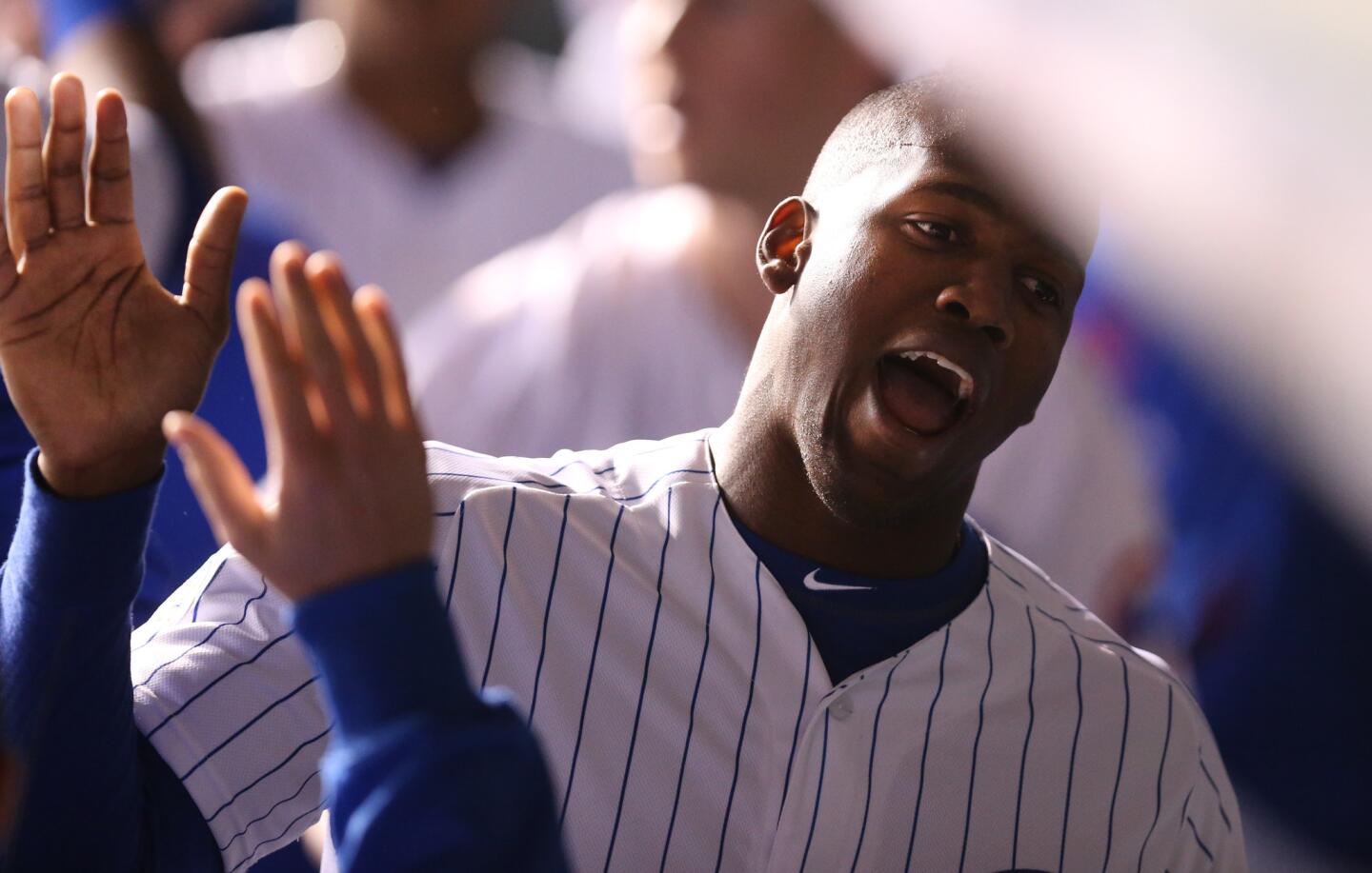 Jorge Soler celebrates with teammate after scoring on a sacrifice fly in the 8th inning.