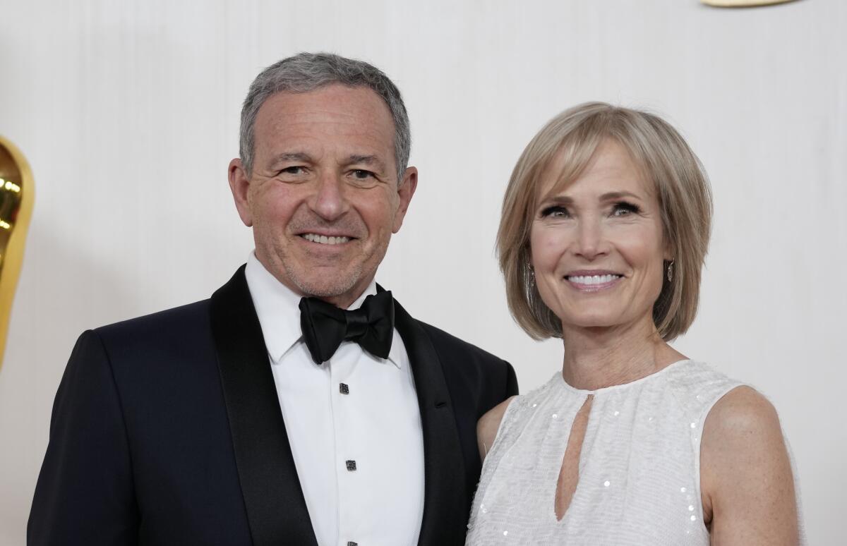 Bob Iger and Willow Bay arrive at the Oscars on in March.