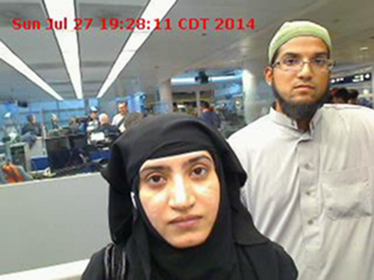 A photo from U.S. Customs and Border Protection shows Tashfeen Malik, left, and Syed Farook as they passed through O'Hare International Airport in July 2014.