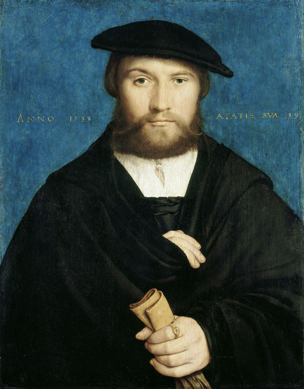A painting of a bearded man in a hat and cloak, clutching rolled up paper.