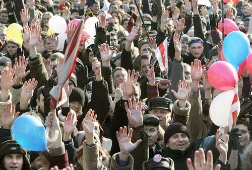 Belarus opposition supporters raise their hands during a rally in Minsk.