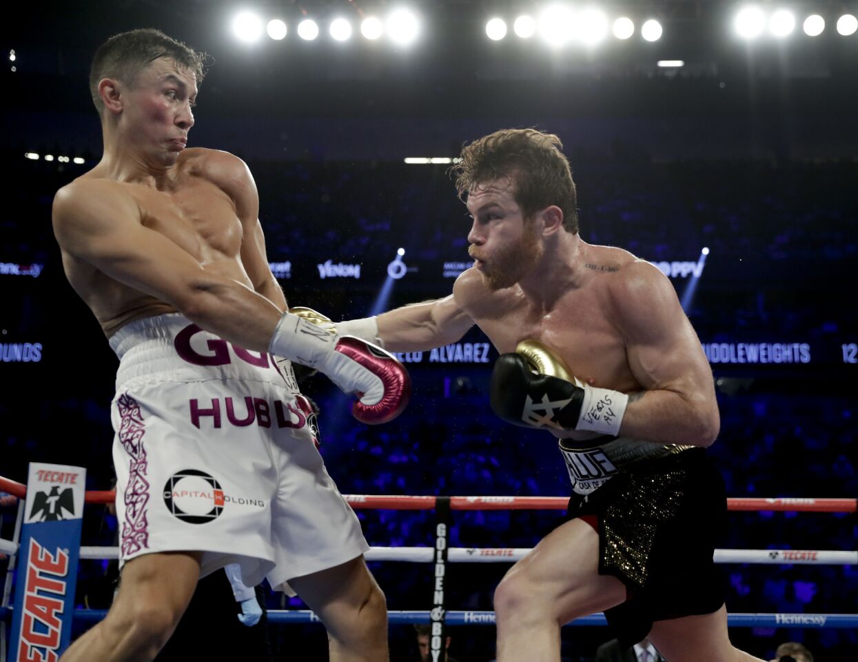 Gennady Golovkin, left, and Canelo Alvarez trade punches in the second round during a middleweight title boxing match, Saturday, Sept. 15, 2018, in Las Vegas.