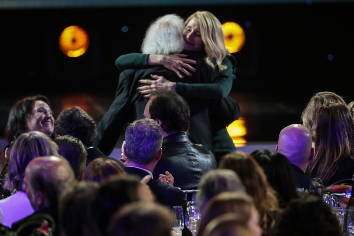 Laura Dern embraces her father, Bruce Dern, after winning the SAG Award for her supporting role in "Marriage Story."